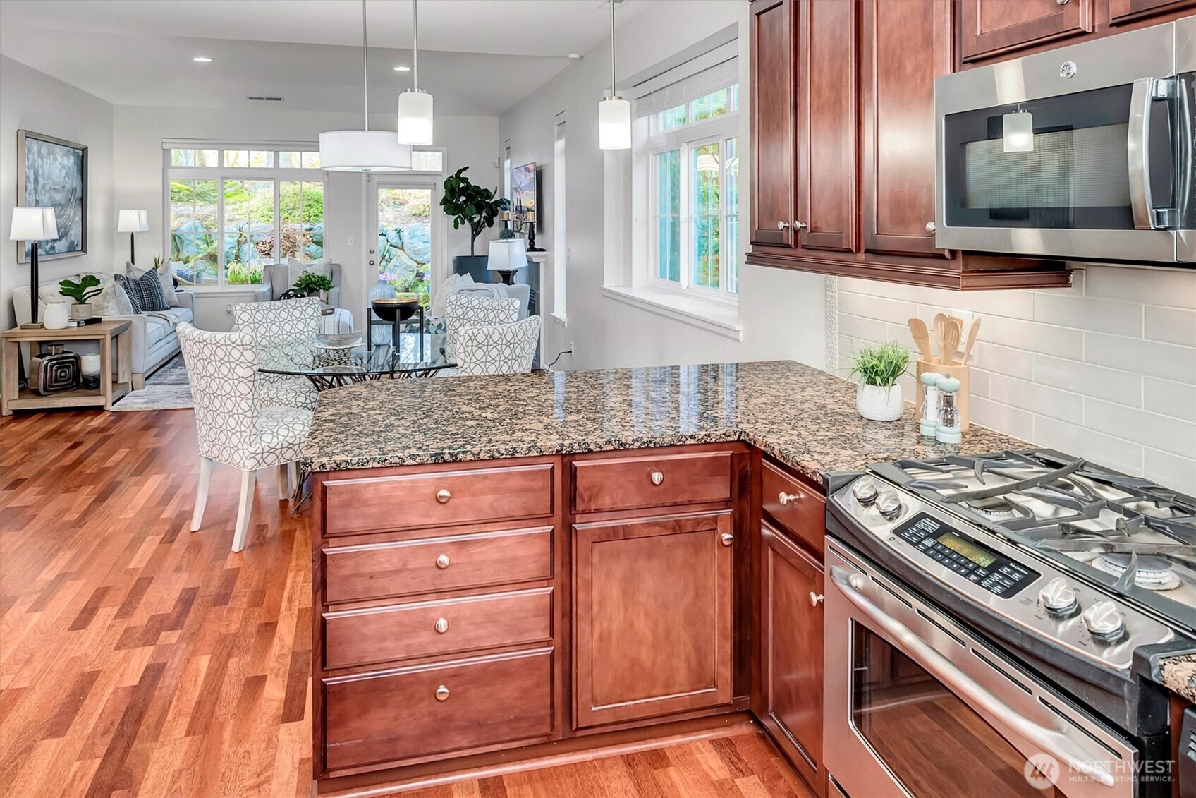 23857 Northeast 112th Circle, Unit 2 Redmond, WA 98053 - Photo 9 of 28 a kitchen with stainless steel appliances granite countertop a stove a sink and a microwave