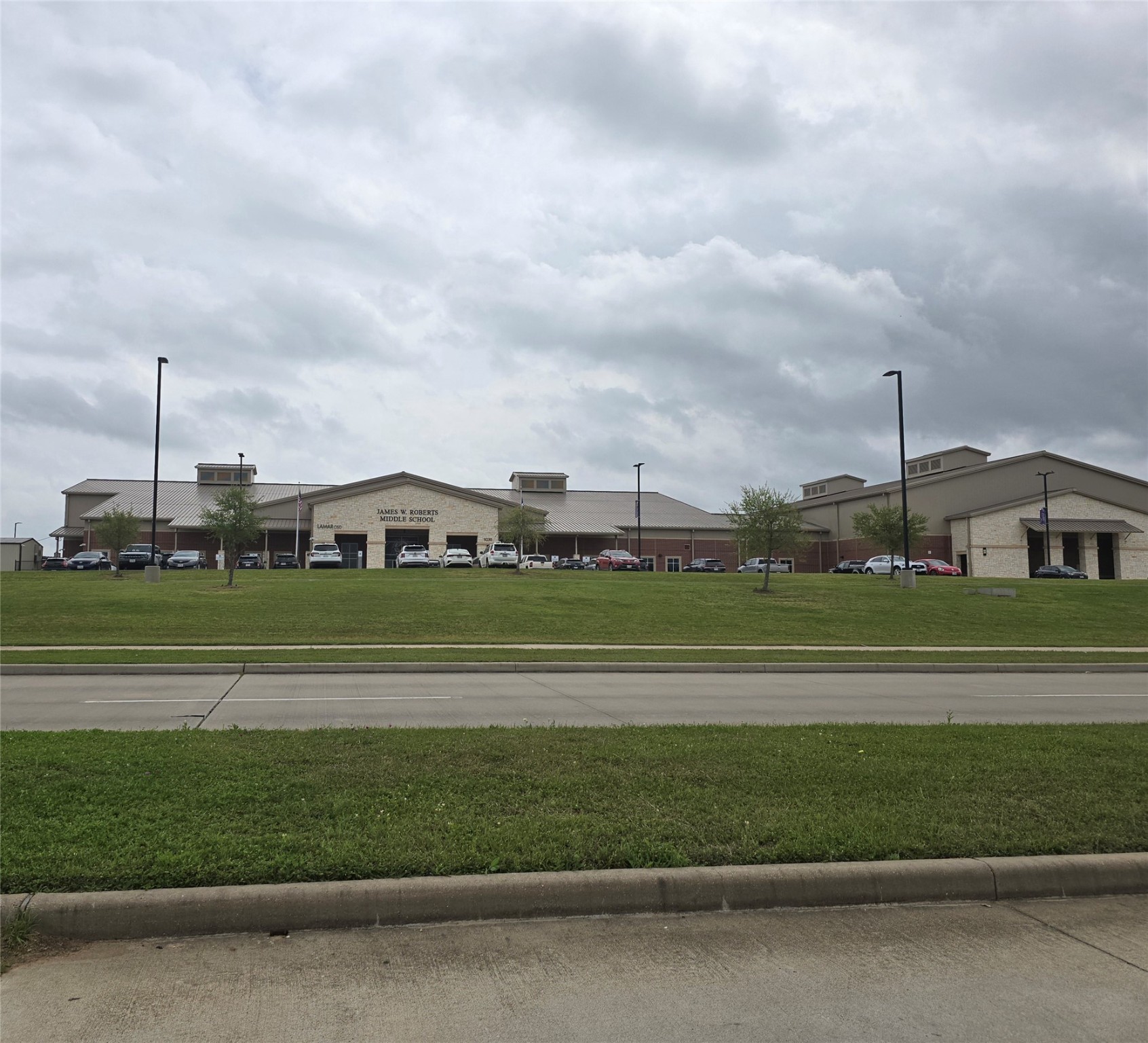 7514 Dixon Road Fulshear, TX 77441 - Photo 7 of 13 a green field with lots of buildings in the background