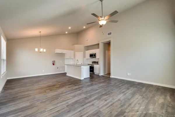 a view of kitchen with granite countertop cabinets and wooden floor