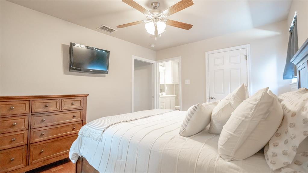 659 Aviator Drive Fort Worth, TX 76179 - Photo 12 of 40 a bedroom with a bed and a flat screen tv