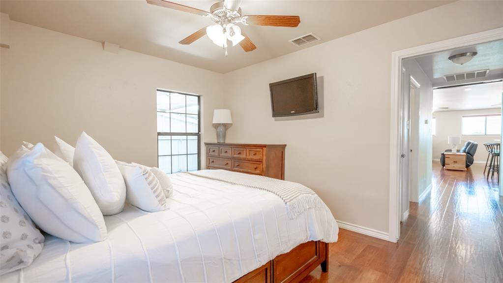 659 Aviator Drive Fort Worth, TX 76179 - Photo 14 of 40 a bedroom with a bed and a chandelier