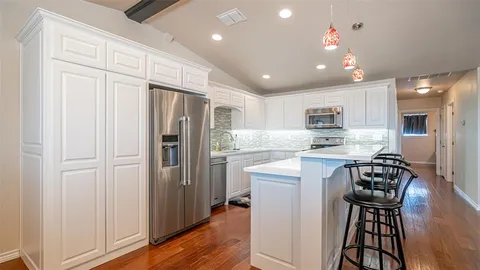an open kitchen with a table and chairs in it