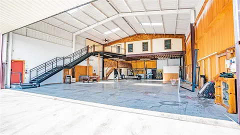 a very nice looking room with wooden floor and furniture