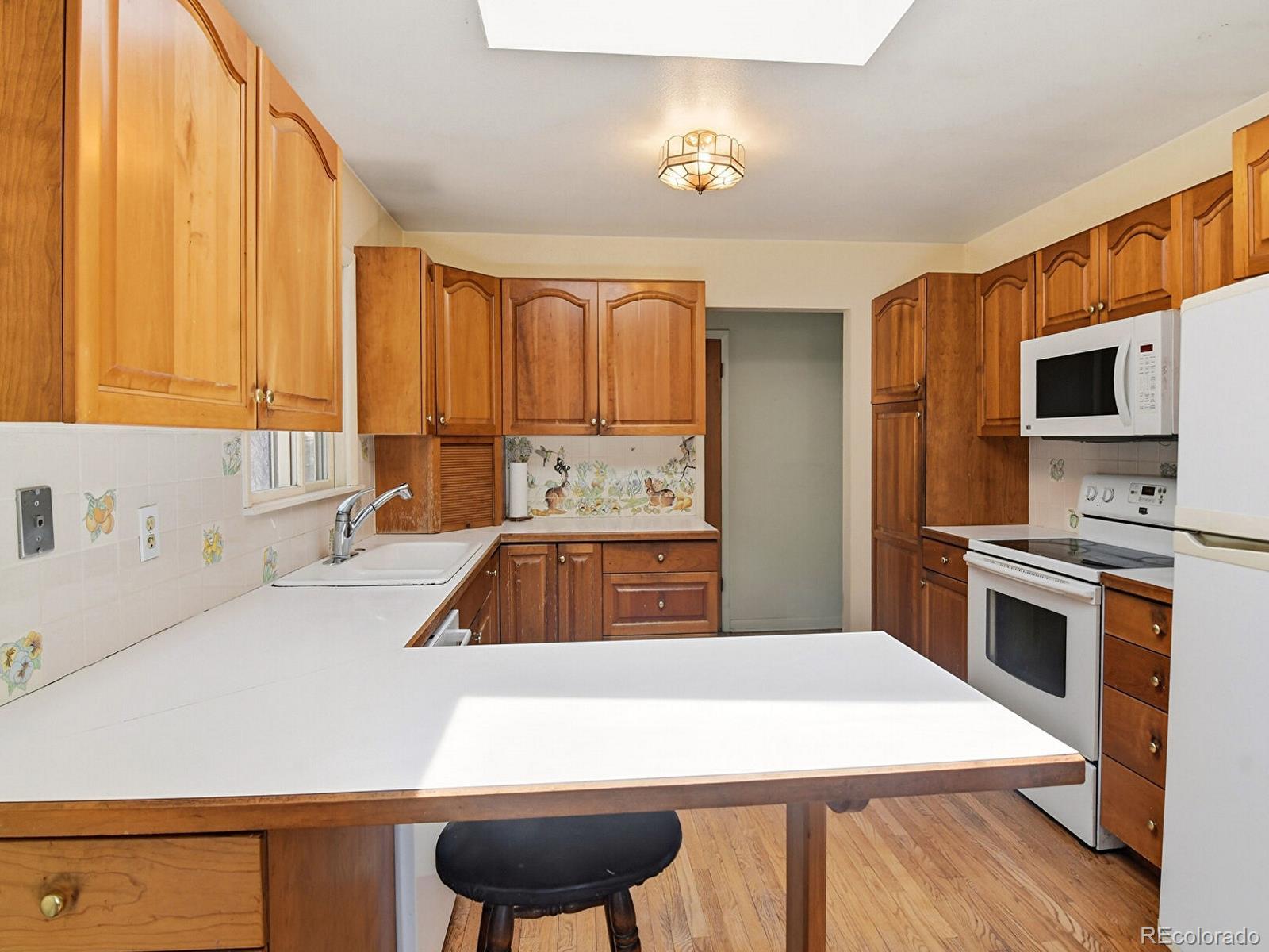 2830 Kerr Gulch Road Evergreen, CO 80439 - Photo 16 of 48 a kitchen with a stove a sink and a refrigerator