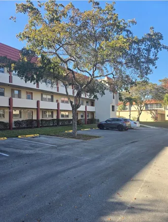 a view of a brick building next to a yard