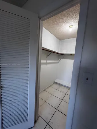 a view of a room with wooden floor and window