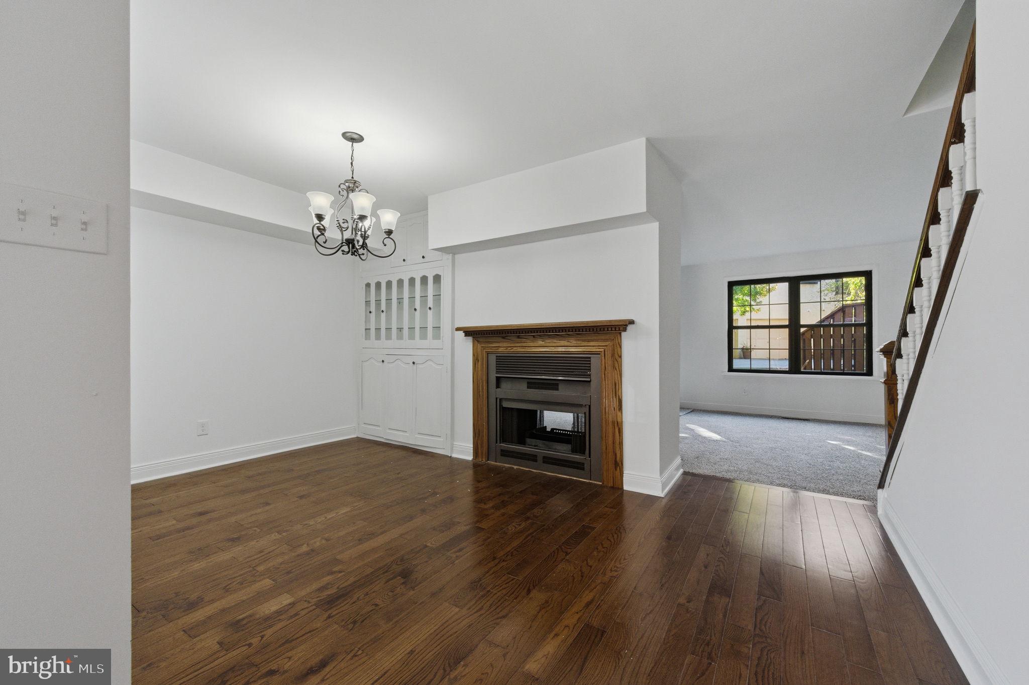 3305 Keswick Way, Unit 3305D Newtown Square, PA 19073 - Photo 11 of 38 wooden floor fireplace and windows in an empty room