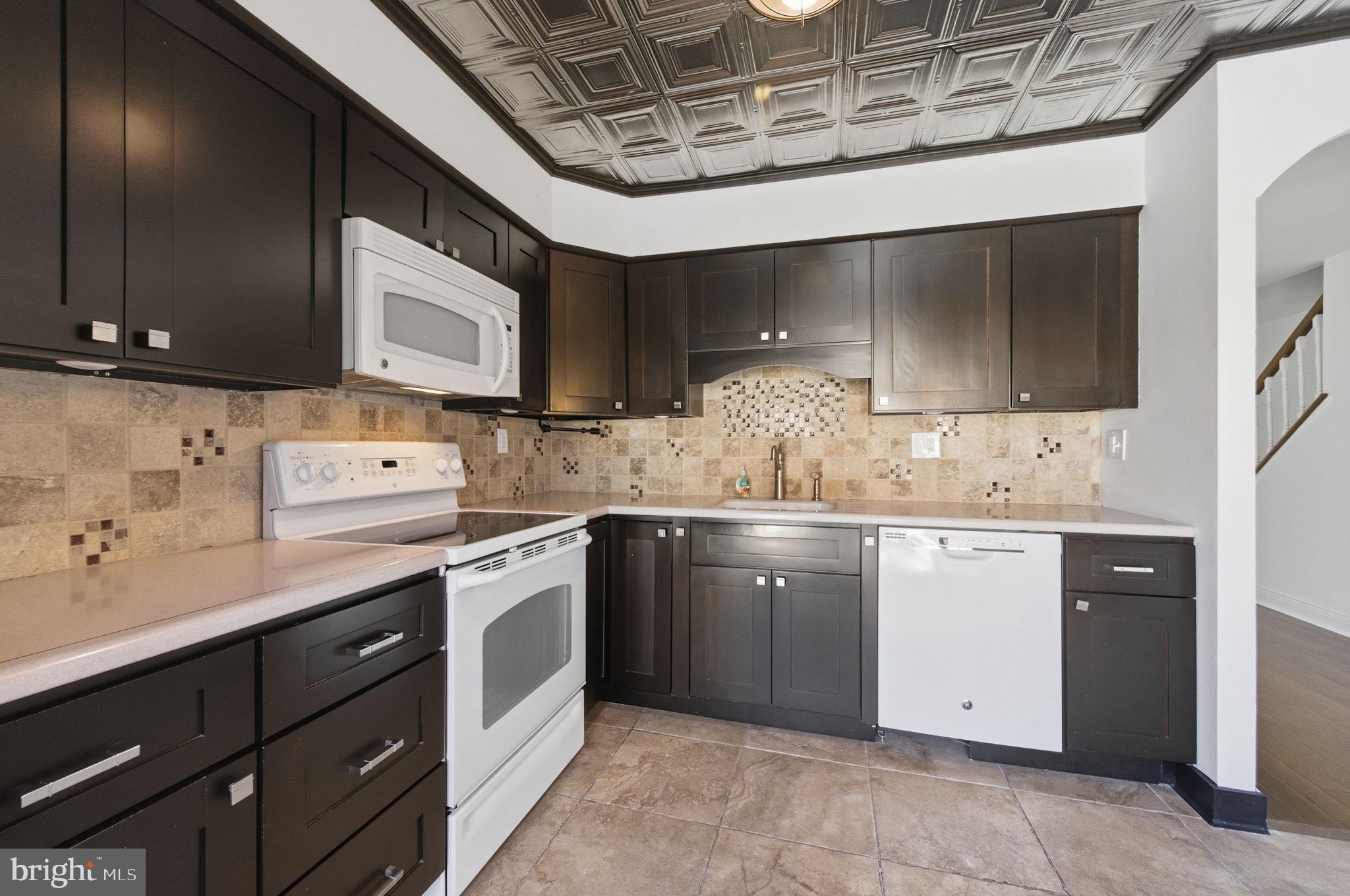3305 Keswick Way, Unit 3305D Newtown Square, PA 19073 - Photo 21 of 38 a kitchen with stainless steel appliances granite countertop a sink and cabinets