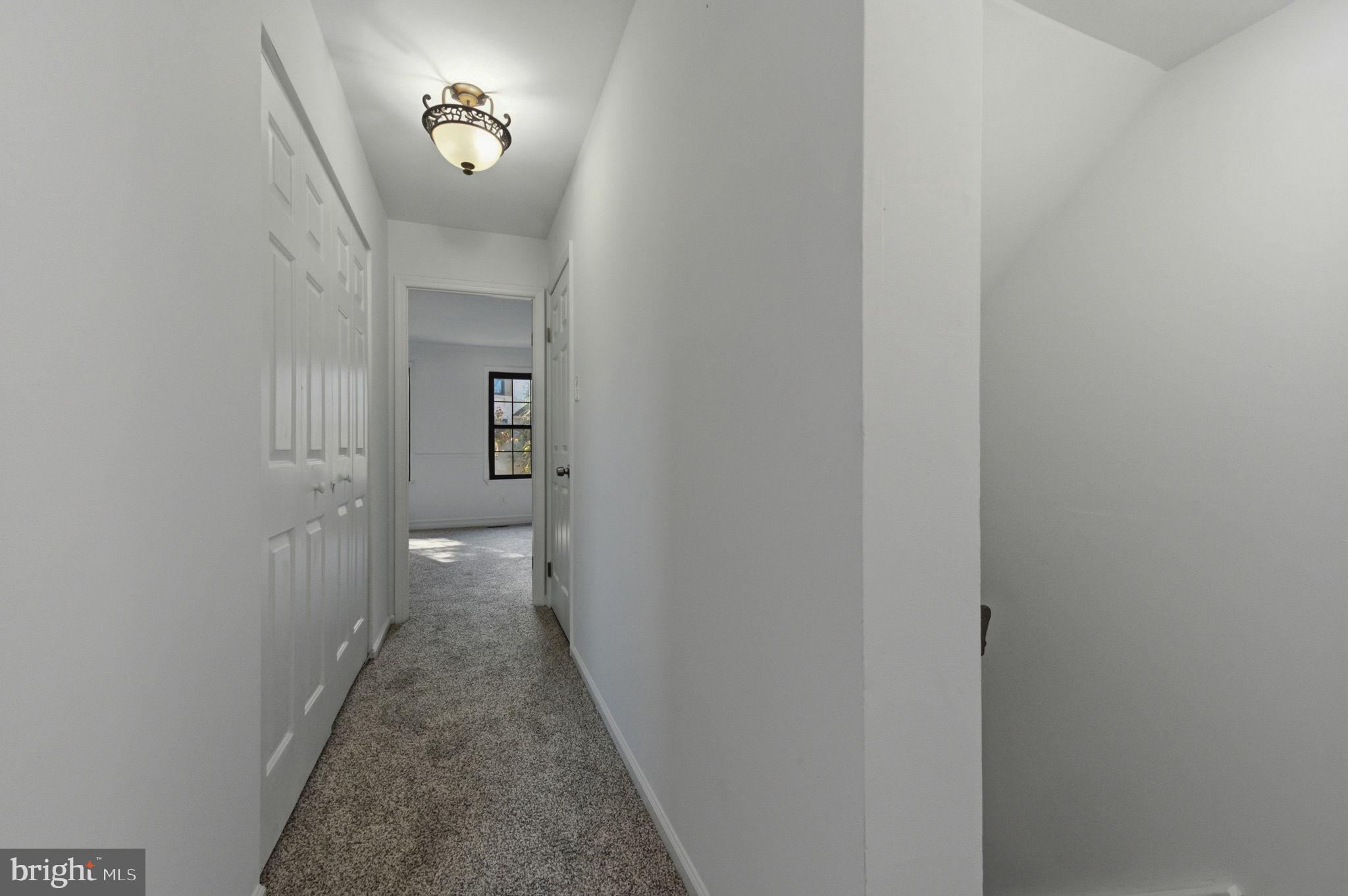 3305 Keswick Way, Unit 3305D Newtown Square, PA 19073 - Photo 22 of 38 a view of a hallway with wooden floor and a bathroom