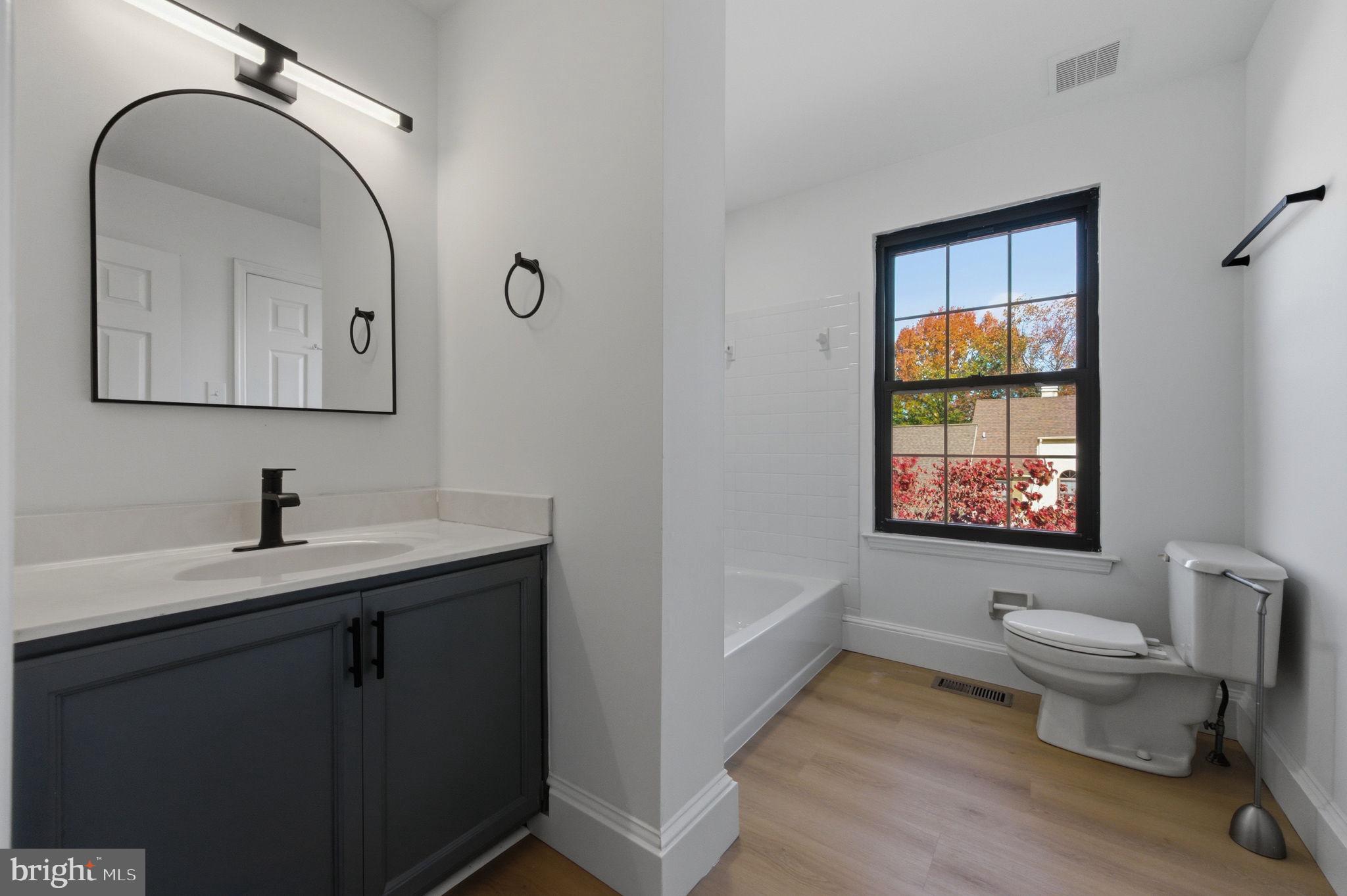 3305 Keswick Way, Unit 3305D Newtown Square, PA 19073 - Photo 23 of 38 a bathroom with a granite countertop sink mirror and toilet
