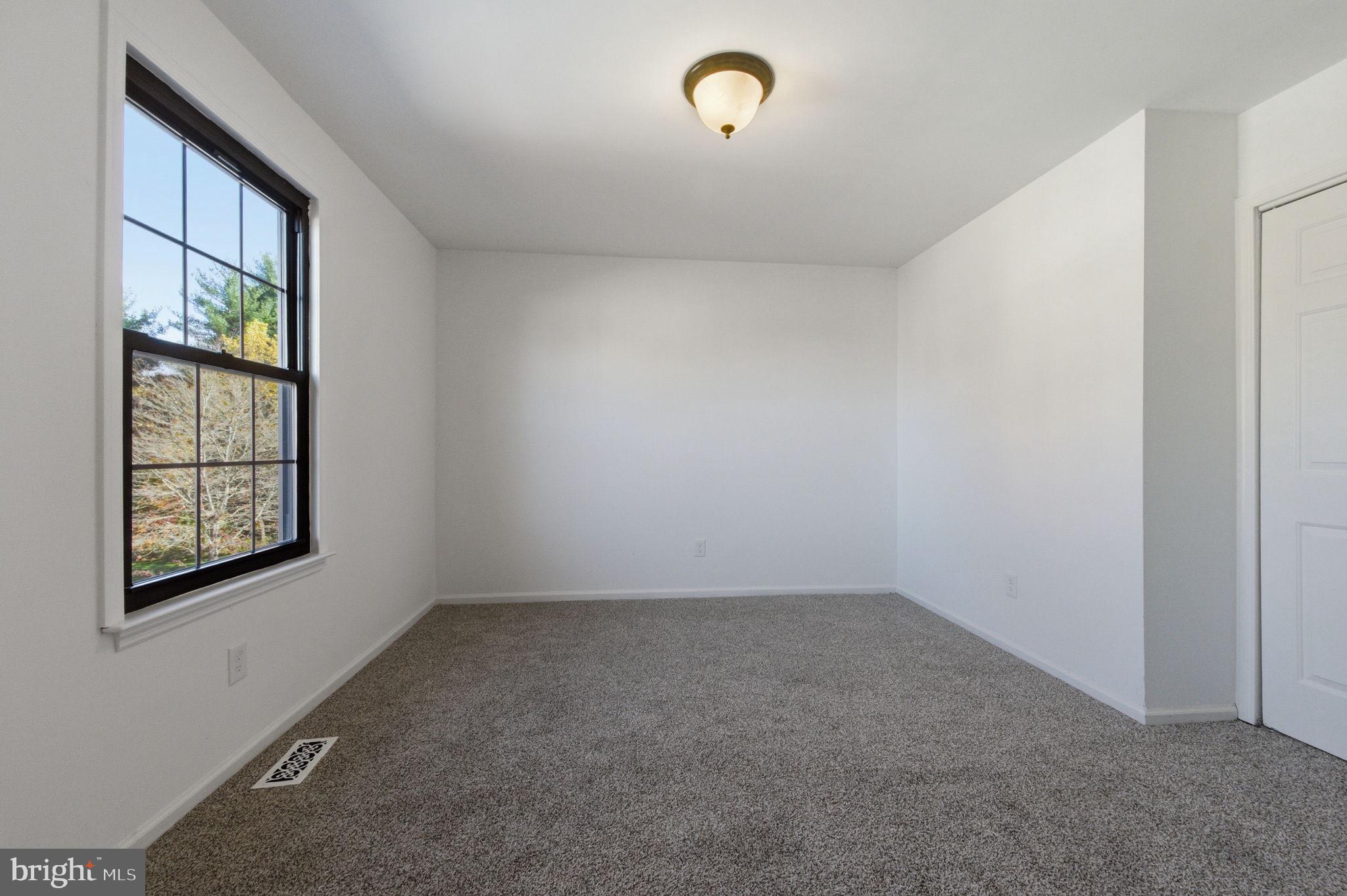 3305 Keswick Way, Unit 3305D Newtown Square, PA 19073 - Photo 26 of 38 an empty room with windows