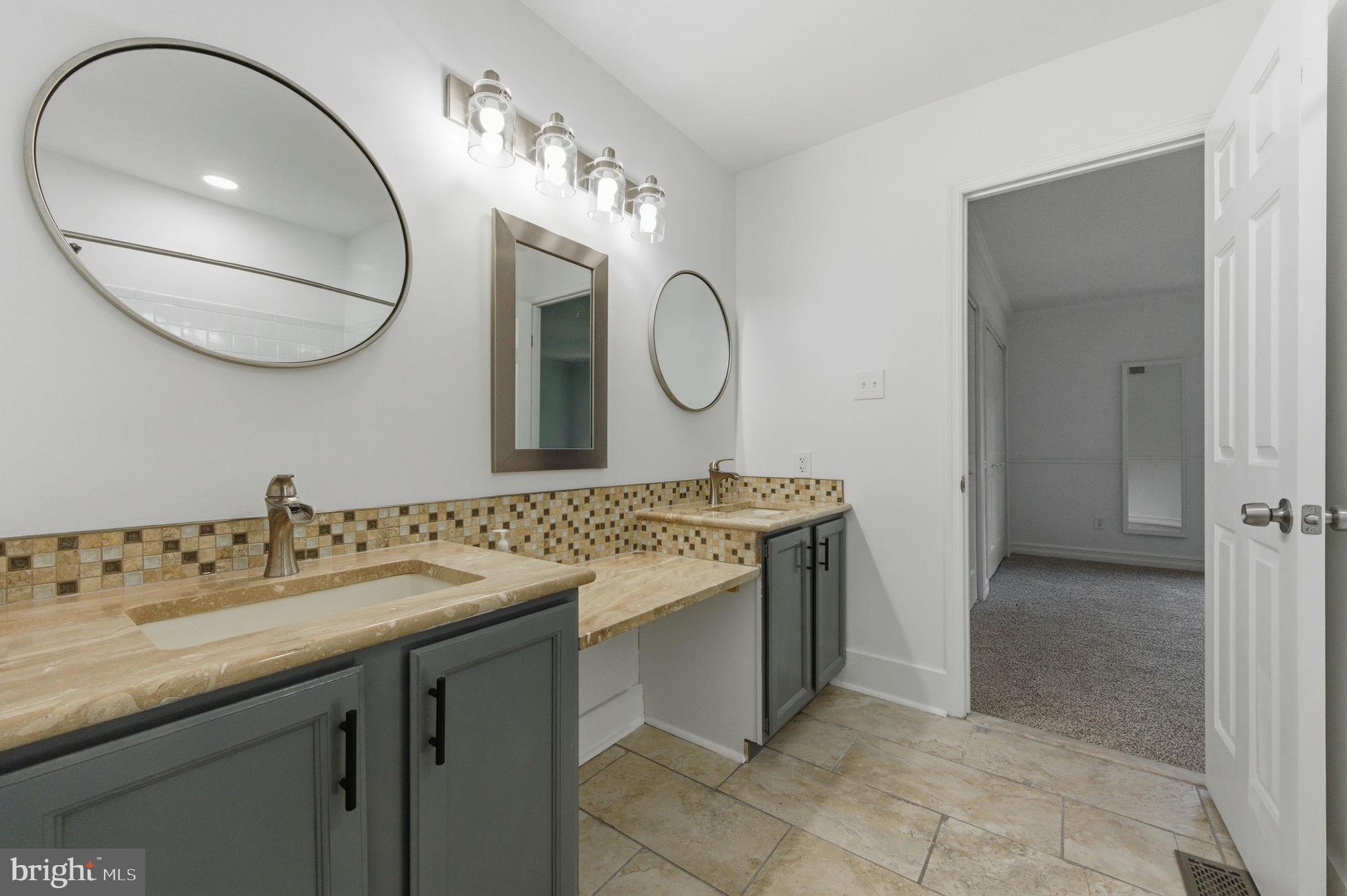 3305 Keswick Way, Unit 3305D Newtown Square, PA 19073 - Photo 33 of 38 a bathroom with a double vanity sink and a mirror