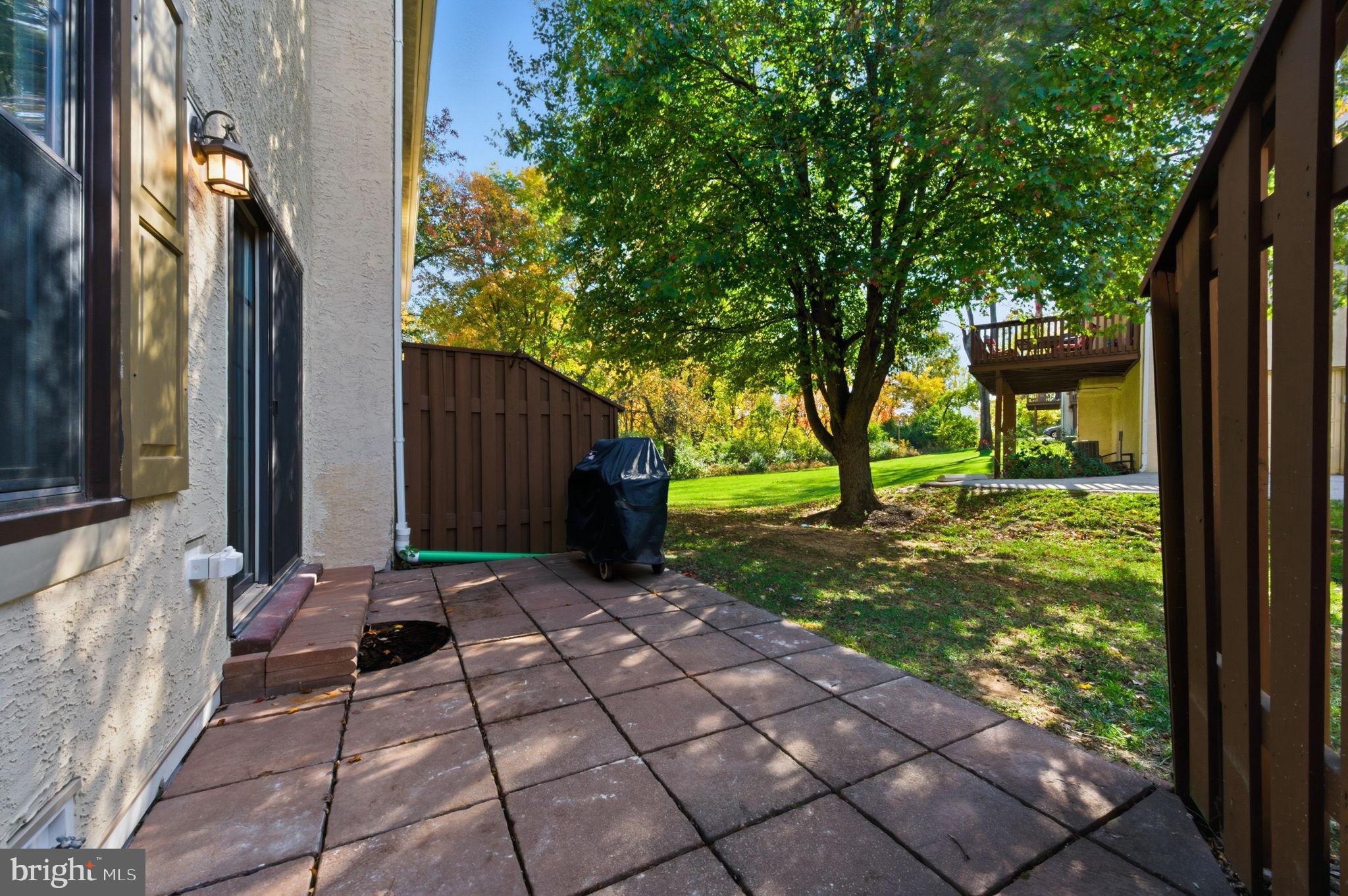 3305 Keswick Way, Unit 3305D Newtown Square, PA 19073 - Photo 6 of 38 a view of backyard with a table and chair and barbeque oven