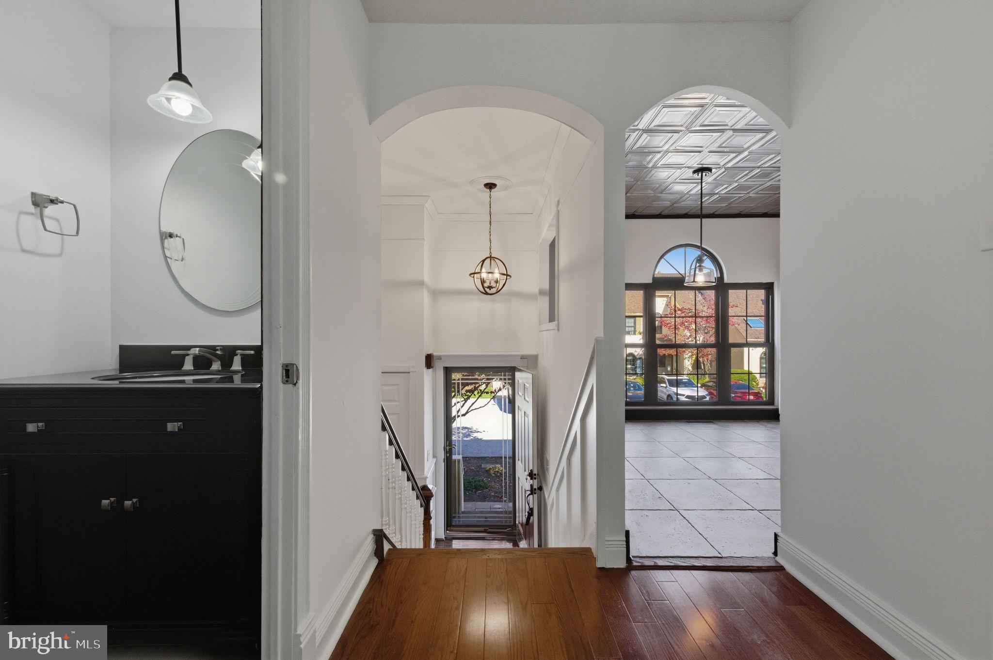 3305 Keswick Way, Unit 3305D Newtown Square, PA 19073 - Photo 9 of 38 a view of a hallway with wooden floor and glass door