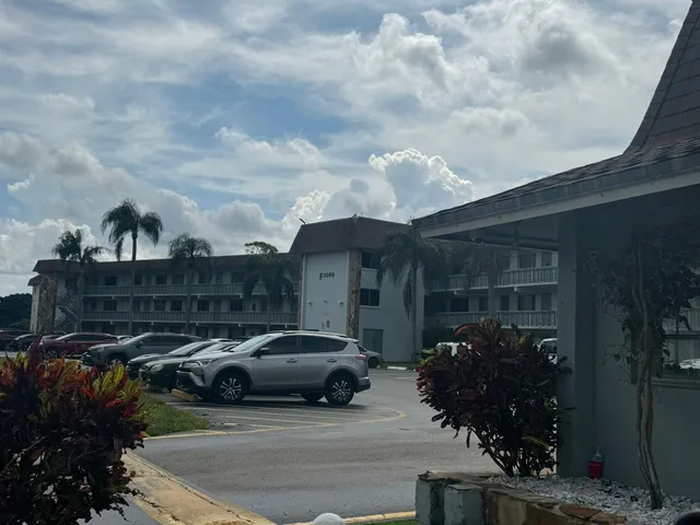 a couple of cars parked in front of a house