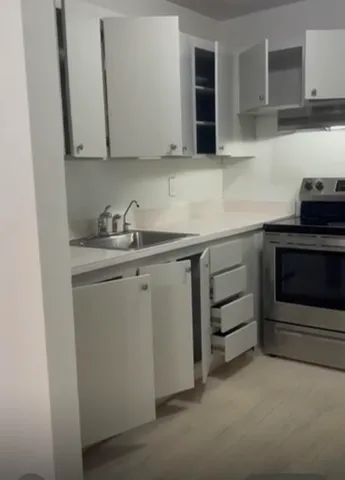 a kitchen with a sink and cabinets