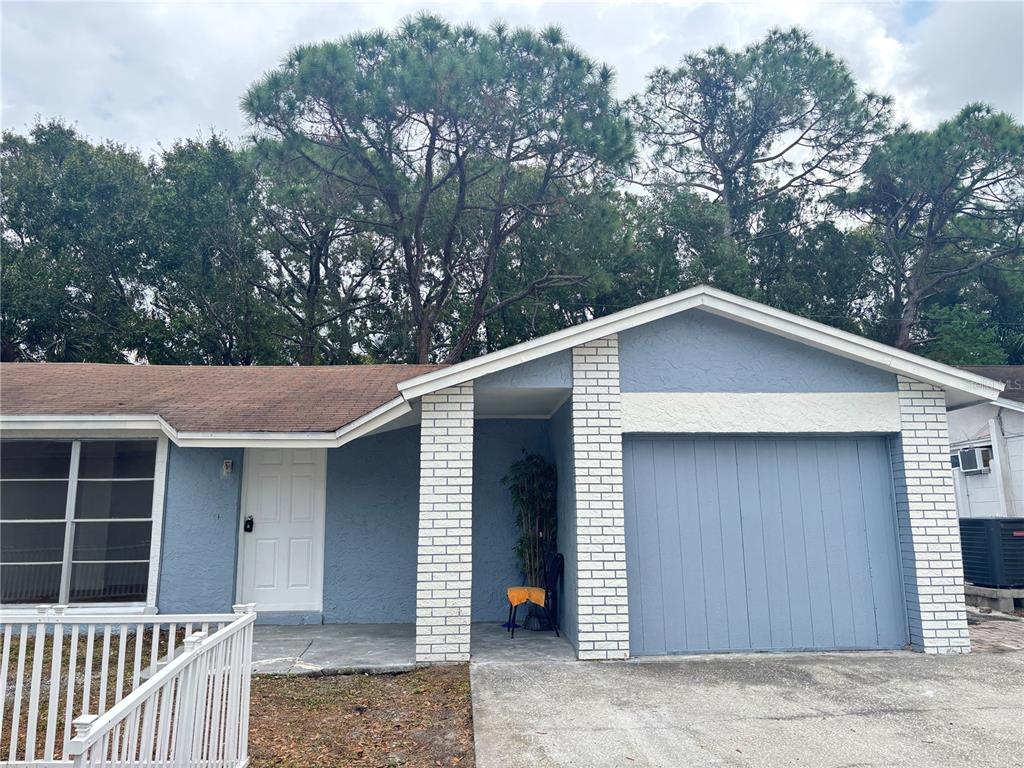 10101 Springtree Court Tampa, FL 33615 - Photo 1 of 1 a house with trees in the background