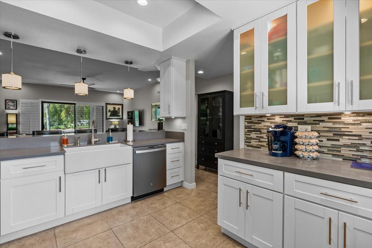 67527 North Portales Drive Cathedral City, CA 92234 - Photo 12 of 47 a kitchen with a refrigerator and white cabinets