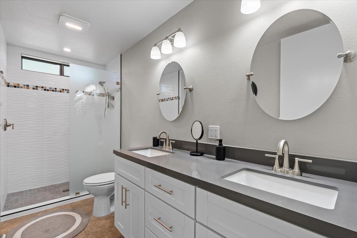 67527 North Portales Drive Cathedral City, CA 92234 - Photo 18 of 47 a bathroom with a double vanity sink toilet and a mirror