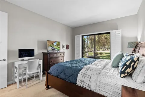 a en suite bathroom with a granite countertop sink and a mirror
