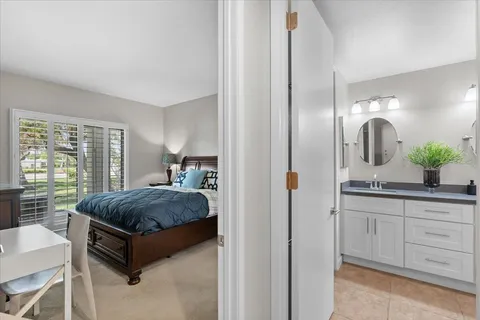 a bathroom with double vanity a toilet a and mirror