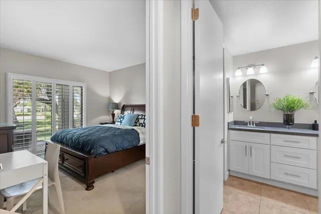 a bathroom with double vanity a toilet a and mirror