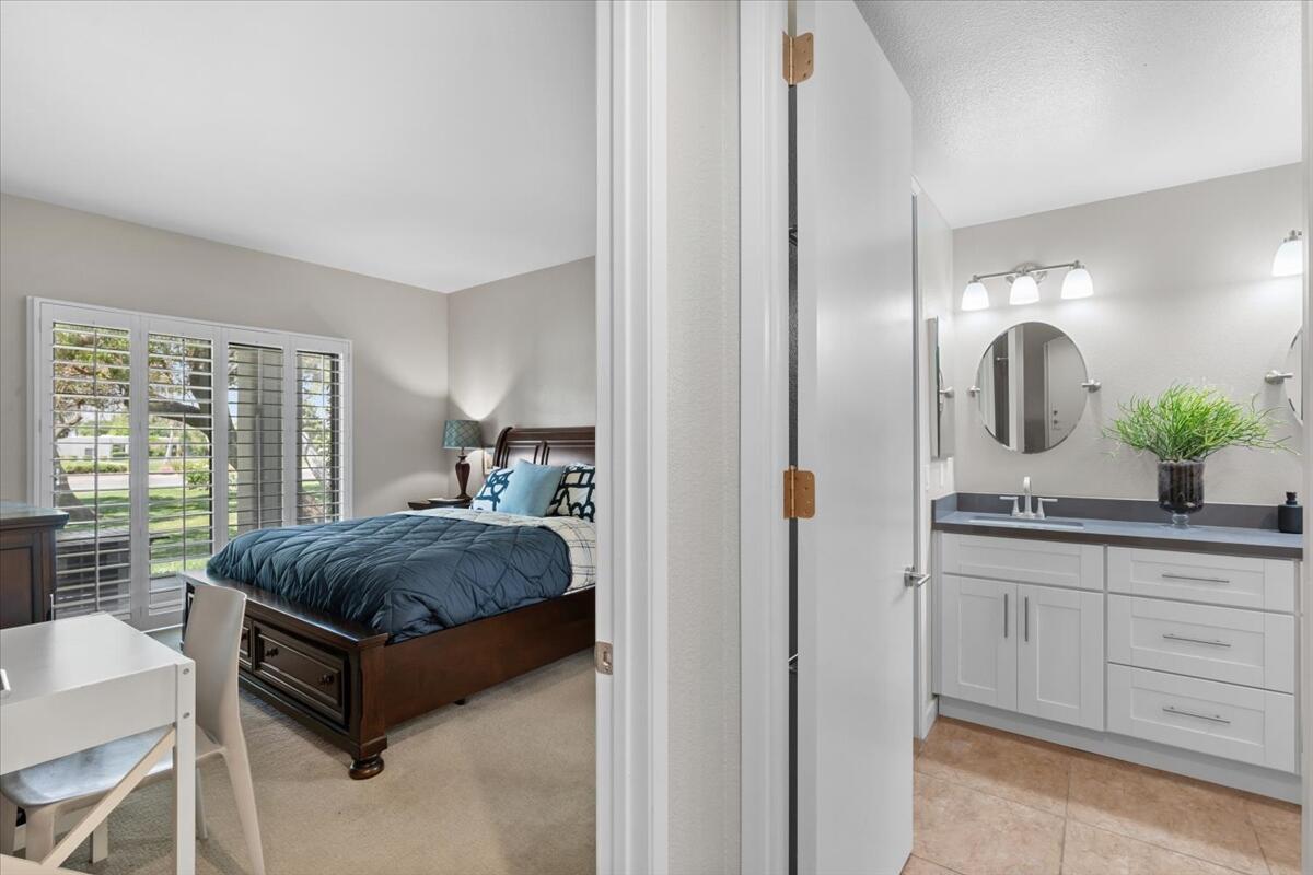 67527 North Portales Drive Cathedral City, CA 92234 - Photo 21 of 47 a en suite bathroom with a granite countertop sink and a mirror