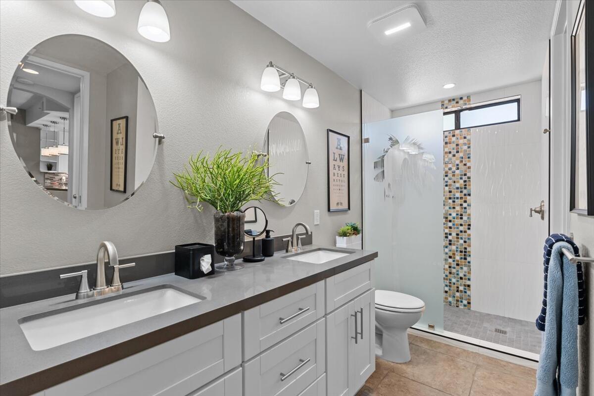 67527 North Portales Drive Cathedral City, CA 92234 - Photo 22 of 47 a bathroom with double vanity a toilet a and mirror
