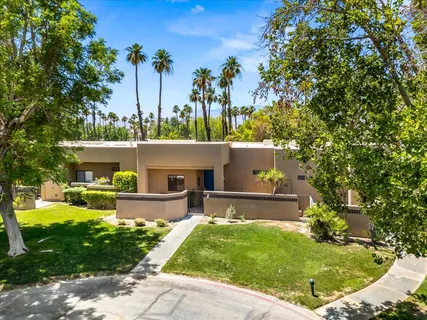 a living room with furniture large window and flat screen tv