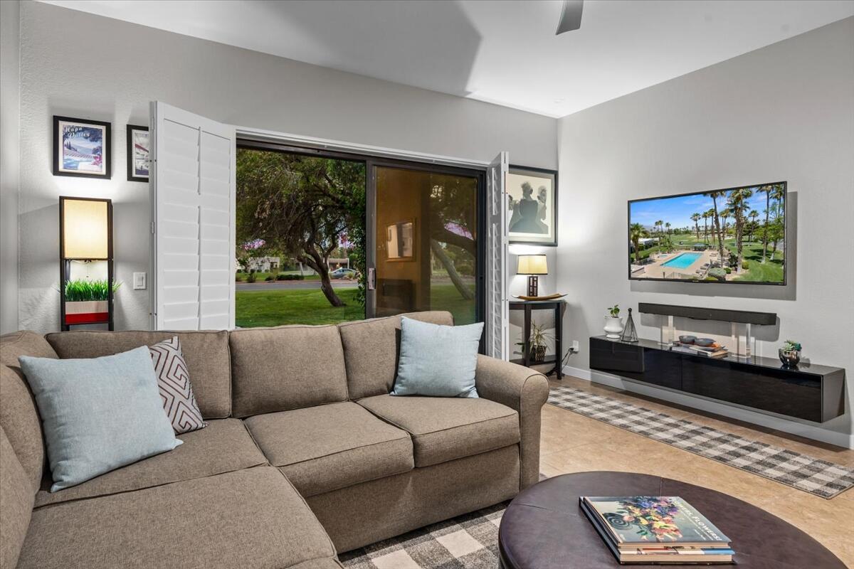 67527 North Portales Drive Cathedral City, CA 92234 - Photo 33 of 47 a living room with furniture large window and flat screen tv