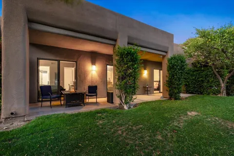 a view of a house with backyard porch and sitting area
