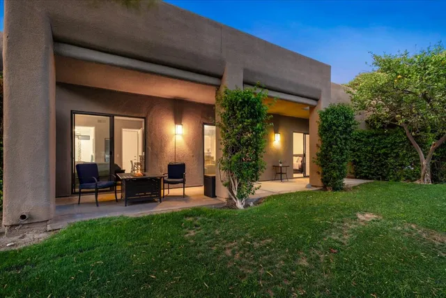 a view of a house with backyard porch and sitting area