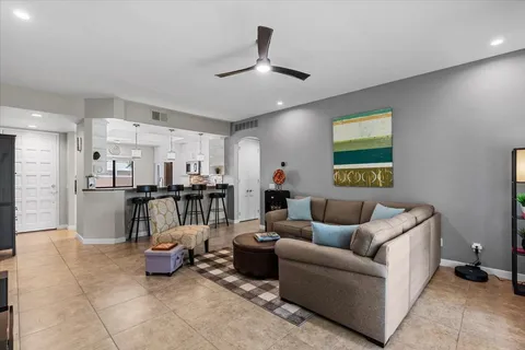 a living room with furniture and kitchen view