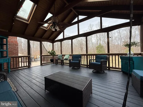 a view of a house with a yard covered in the forest