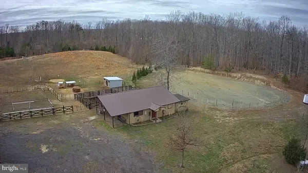 a view of a dry yard with wooden fence