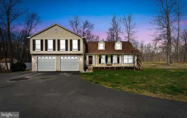 a view of a house with a yard and balcony