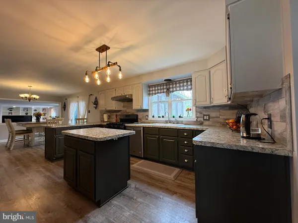 a dining room with furniture and wooden floor