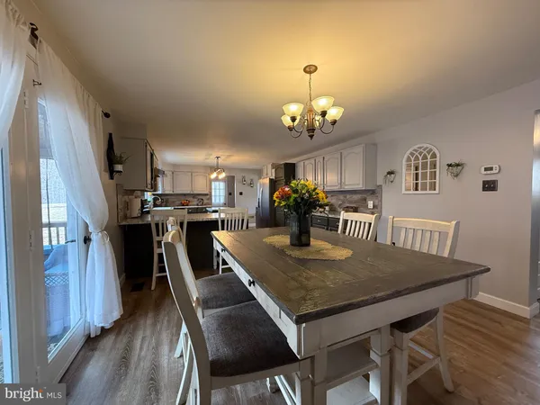 a view of a livingroom with a ceiling fan and window