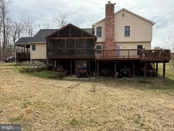 a wooden house with tall trees in front of it