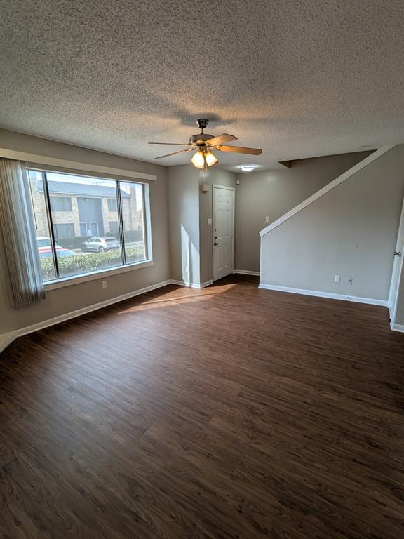 514 East Belt Line Road, Unit B13 DeSoto, TX 75115 - Photo 5 of 28 an empty room with wooden floor chandelier fan and windows