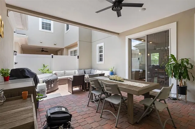 a view of a livingroom and dining room with furniture wooden floor and a rug