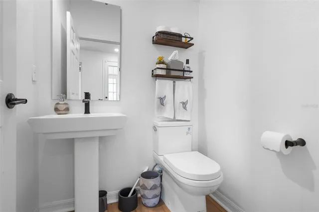 a bathroom with a toilet sink and mirror