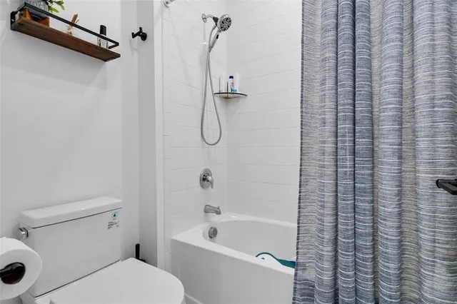 a bathroom with a toilet and a bathtub