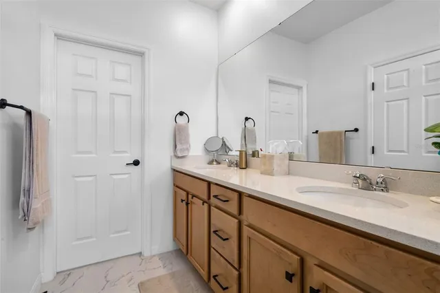 a bathroom with a double vanity sink and mirror