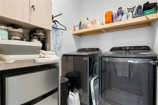 a utility room with sink dryer and washer