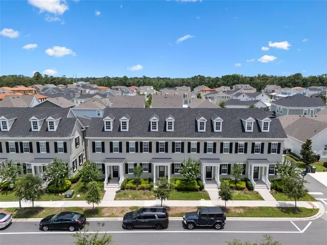 a view of building with lot of cars parked in front of it