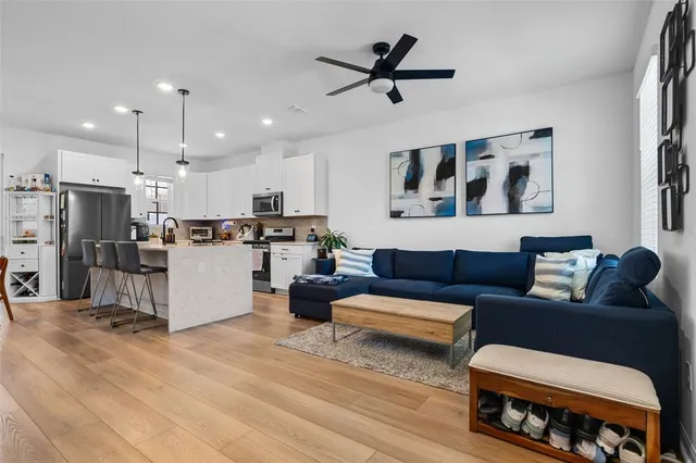 a living room with furniture and kitchen view