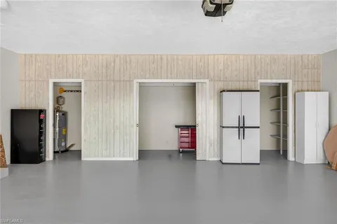 a view of a kitchen with refrigerator and car parked