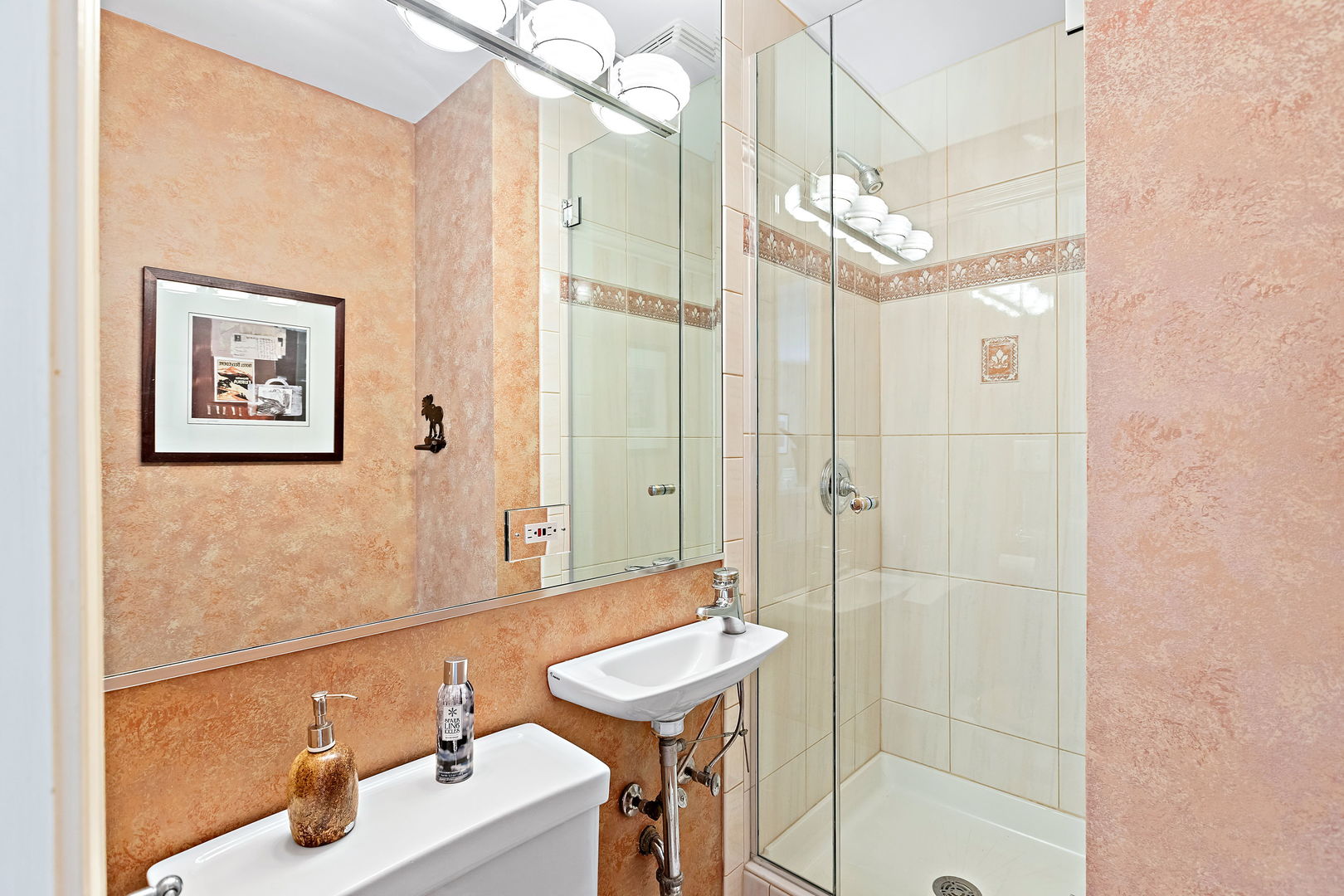 N543 Herrick Drive Wheaton, IL 60187 - Photo 12 of 29 a bathroom with a sink a mirror and a shower