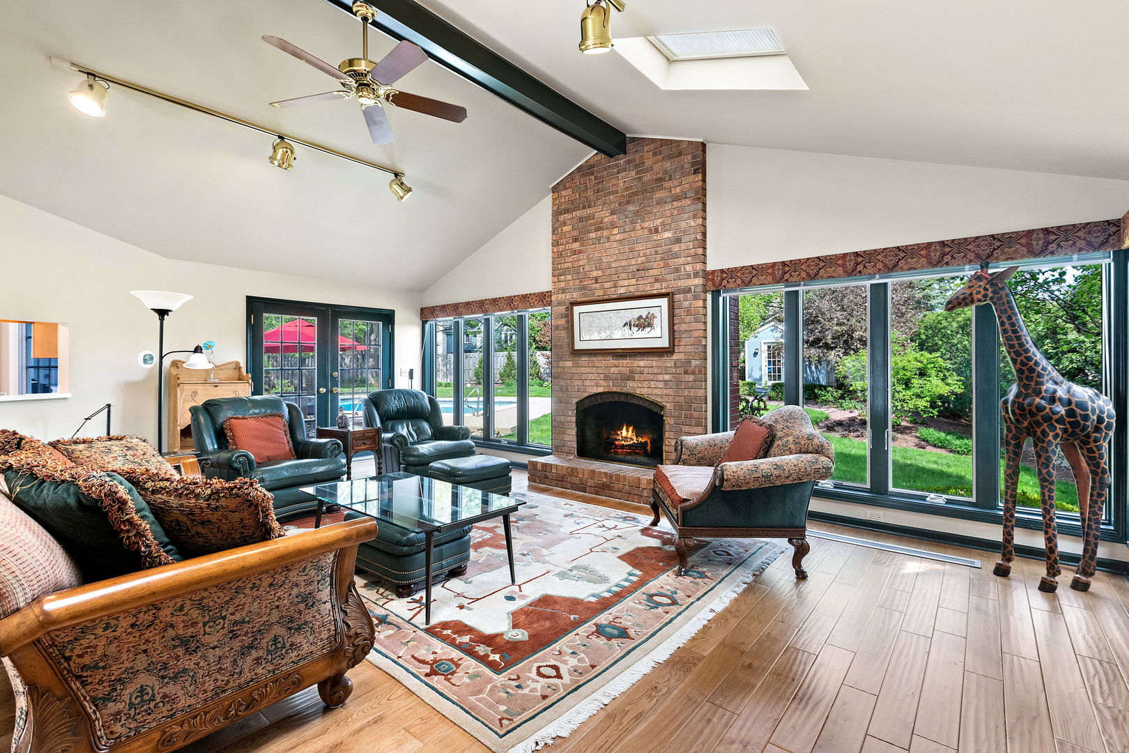 N543 Herrick Drive Wheaton, IL 60187 - Photo 9 of 29 a living room with furniture a fireplace and a floor to ceiling window